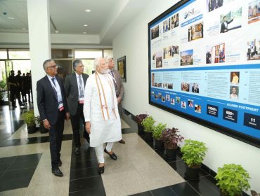 Prime Minister Modi studying a timeline of ISB's achievements during his visit to the Hyderabad campus 